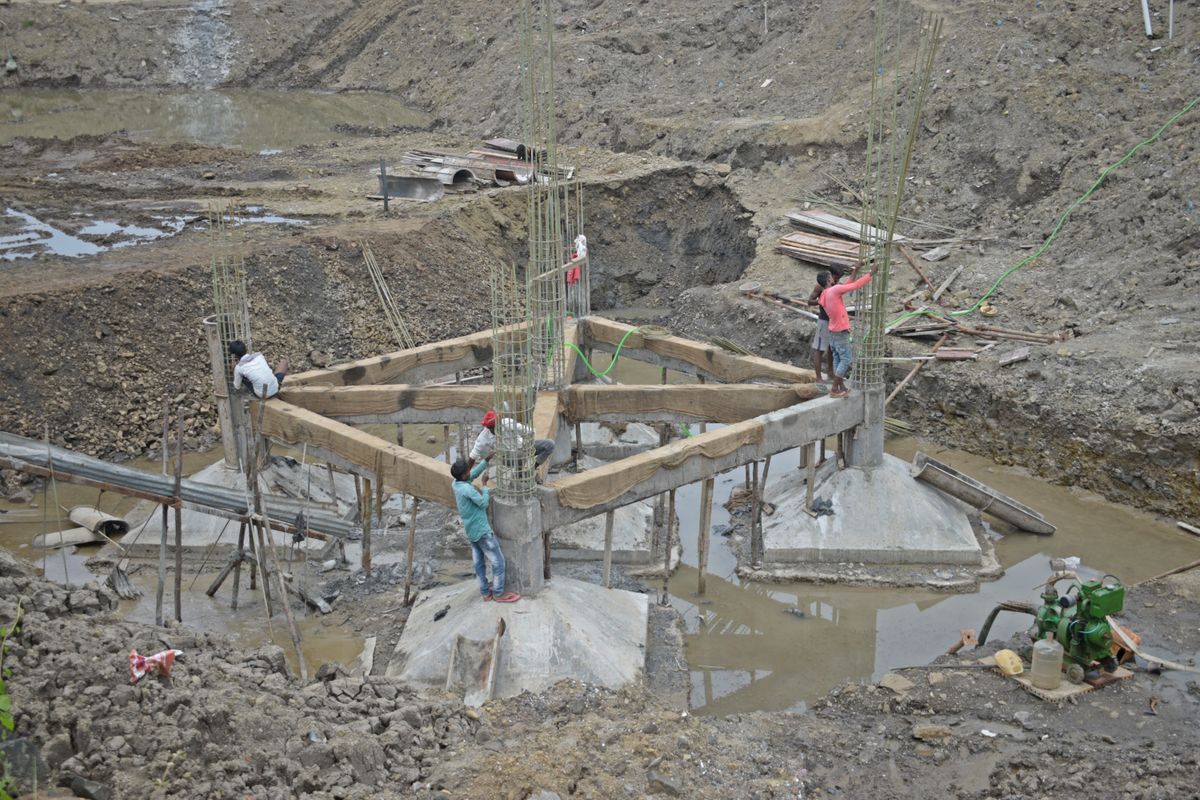 Construction workers building concrete columns and foundations